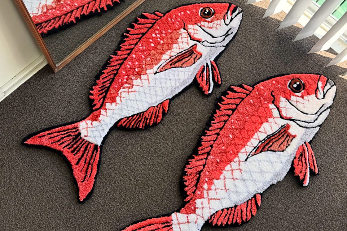 Two hand-tufted snapper rugs finished on the studio floor at Rez Rug Studio